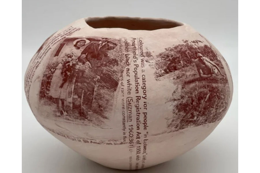 a photo of a pot with words and people on it