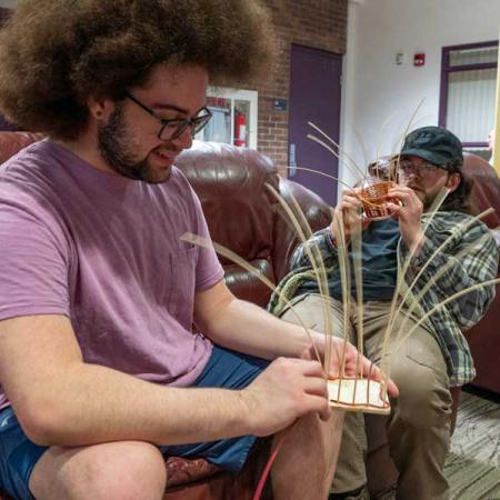 some students working on weaving together a basket