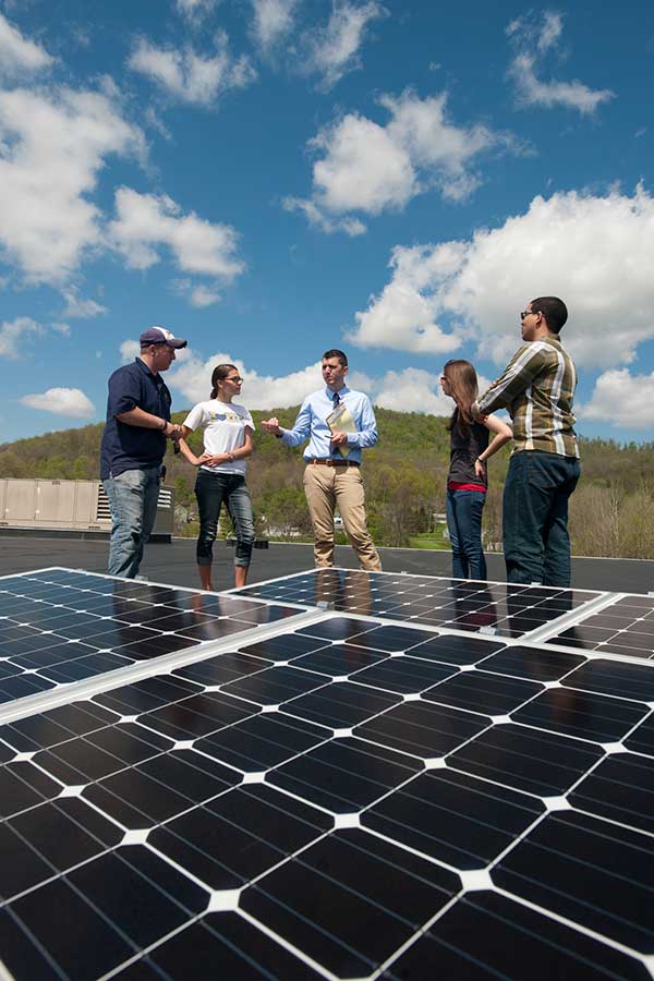 Students around solar panel