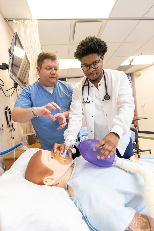 Nursing student with mannequin