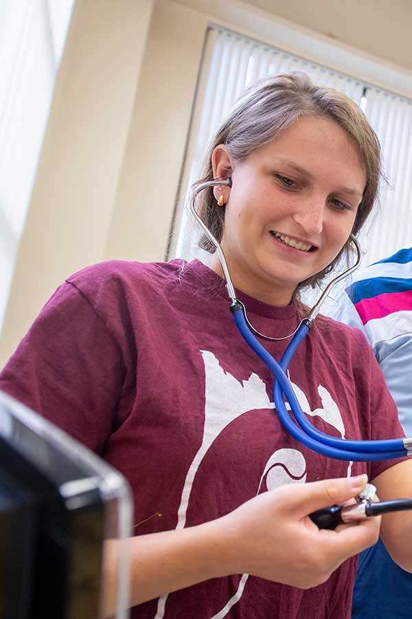 Student using stethoscope