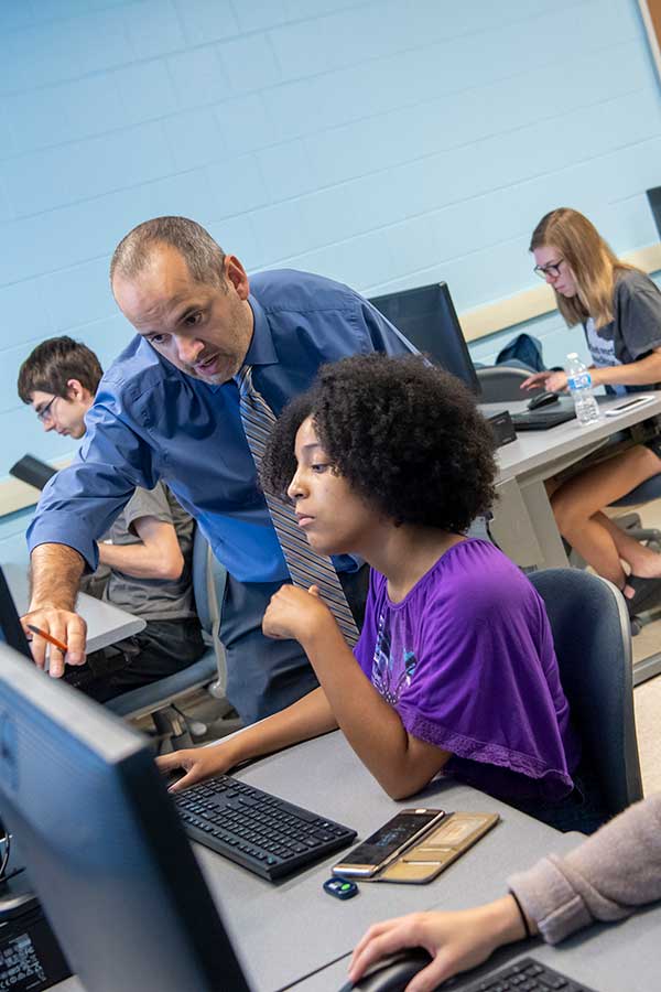 Professor at computer with student