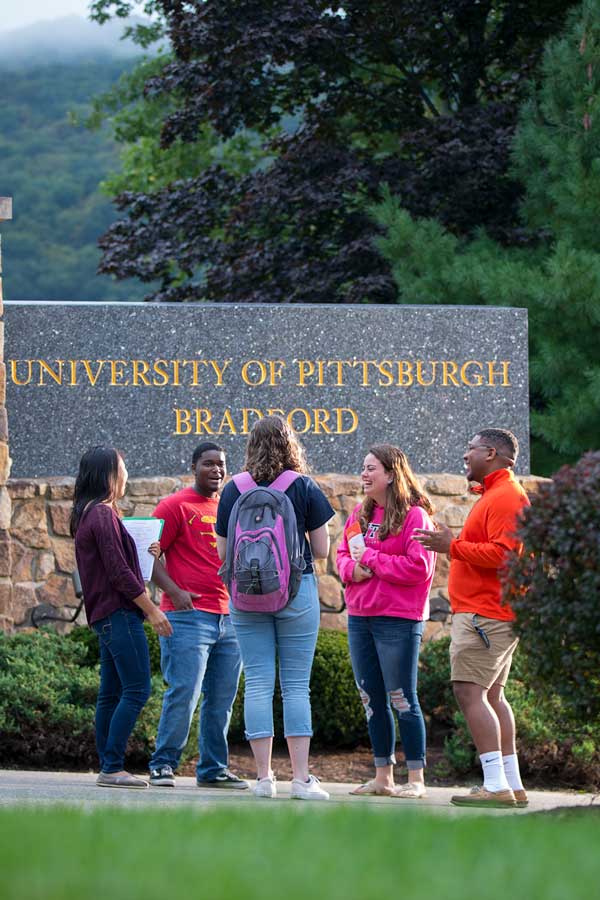 Students below entrance sign