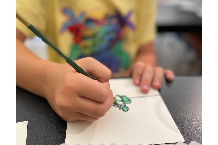 A child painting during a summer art camp