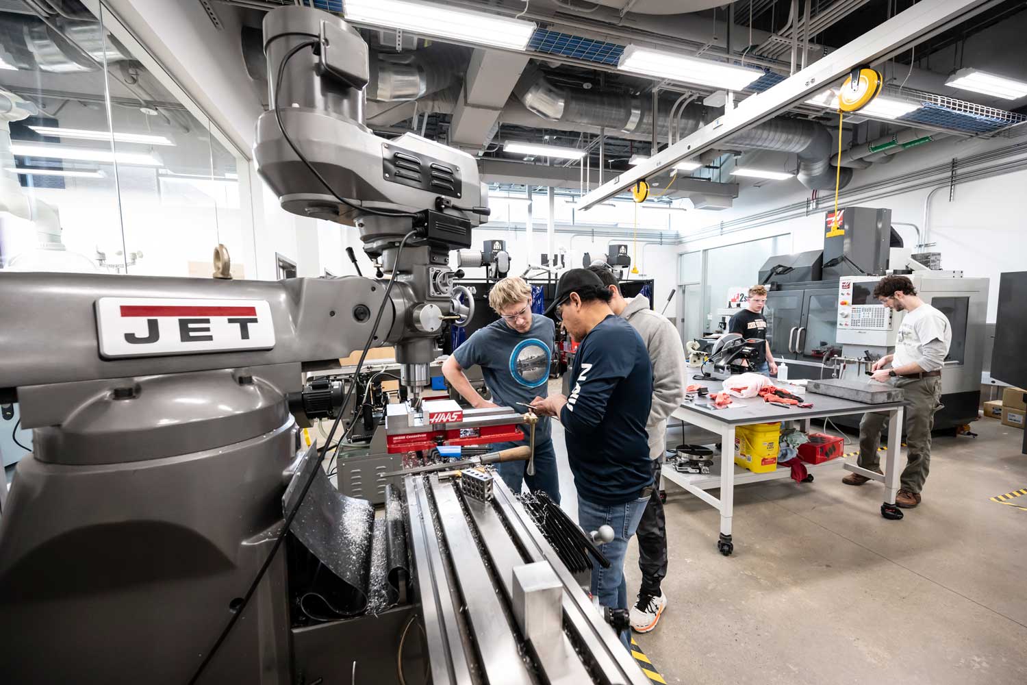 Students working on a machine in the machine shop