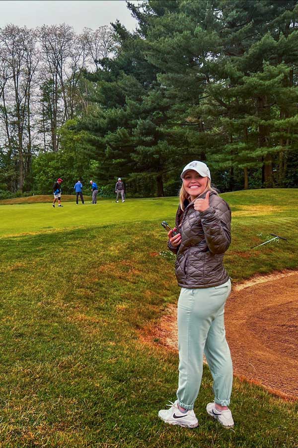 Student taking pictures on a golf course