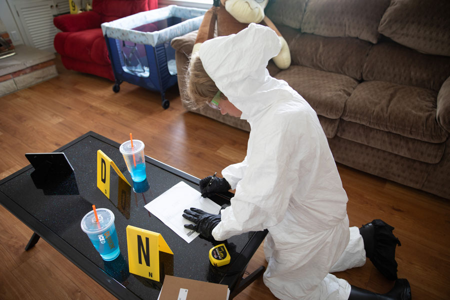 A child working with evidence in the CSI house