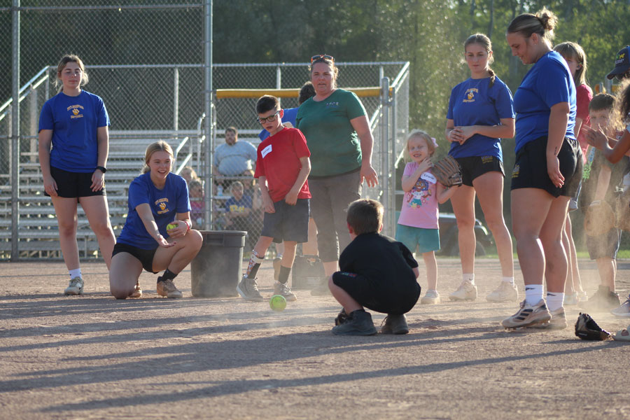 Pitt-Bradford softball players playing with local children