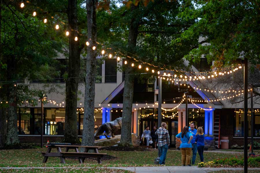 People socializing during Light Up the Quad on AFW