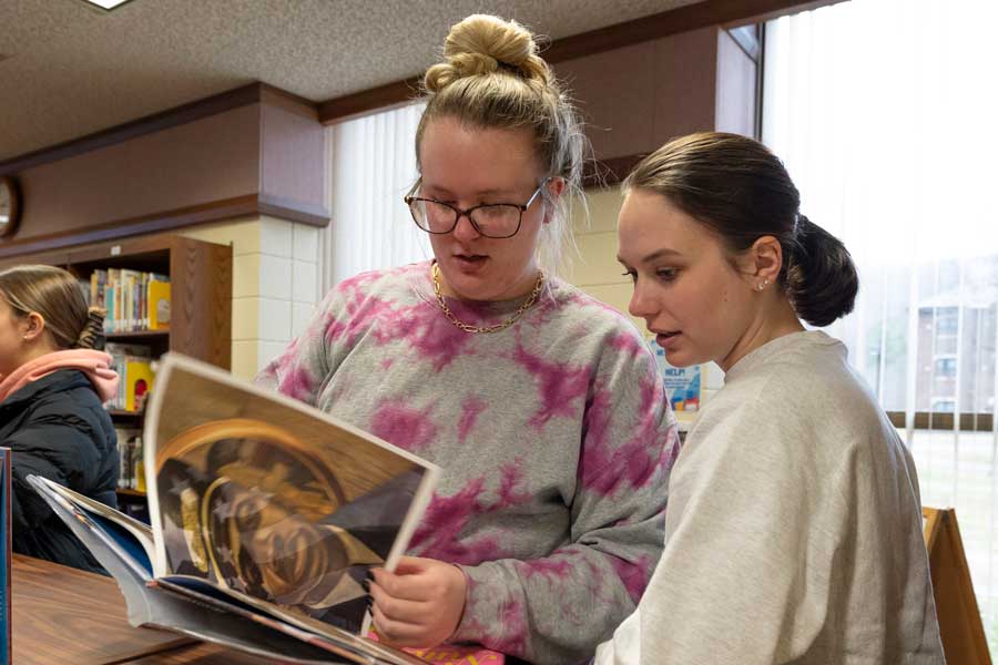 Students in childrens book section of library