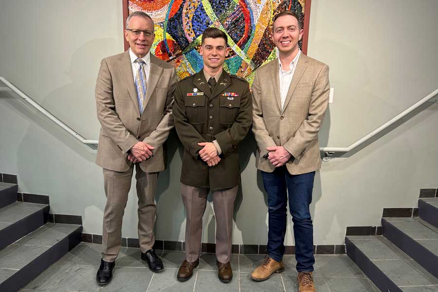 Photo of Nikolas Erickson with President Esch and Dean Davila