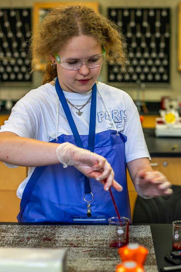 Student experimenting with blood splatters
