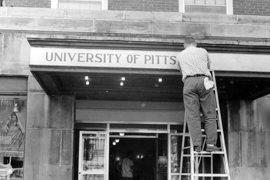 University of Pittsburgh at Bradford lettering being installed on a building