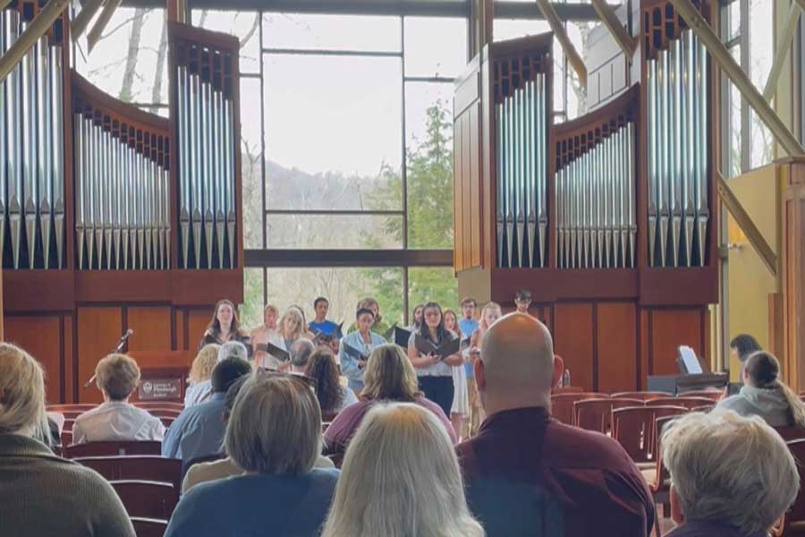 audience attending the vocal concert with singers in the front of the room