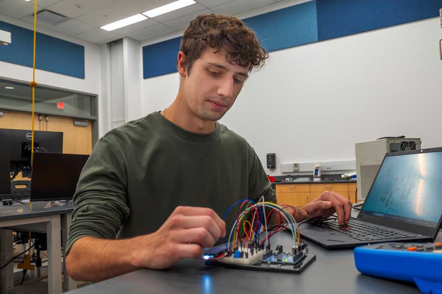 Student, Alex Marrone, working with circuits