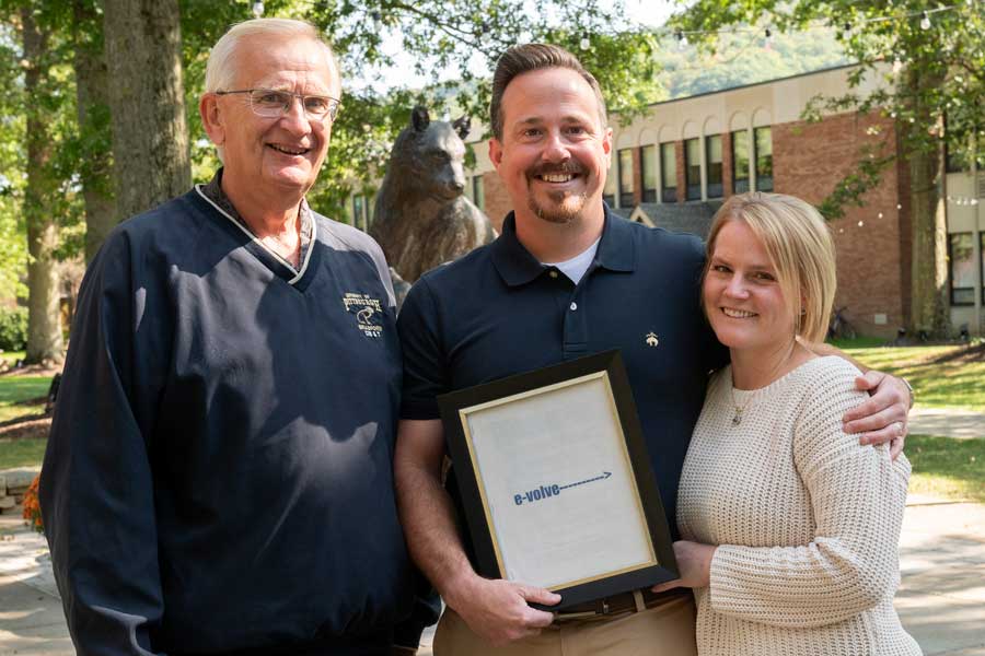 Don Lewicki and the Kemick's in front of panther statue