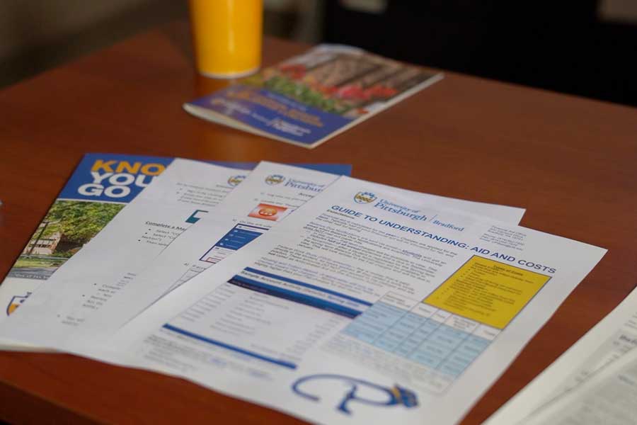 Different financial aid documents on a table