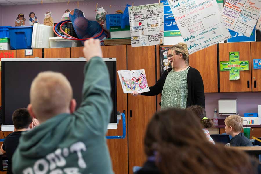 A student teacher reading to children in class