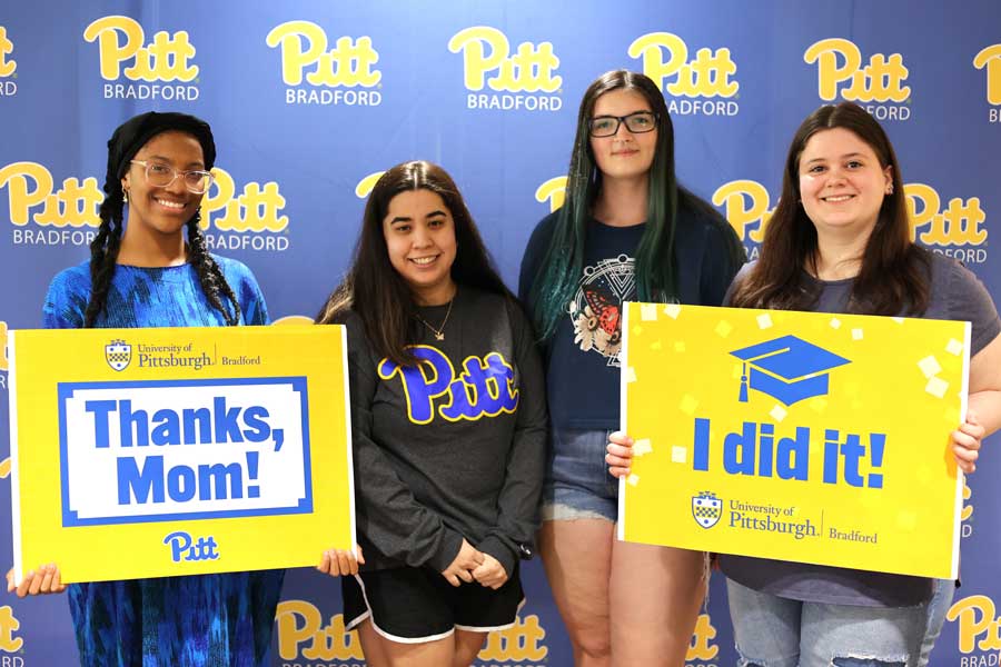 Students smiling for a graduation picture