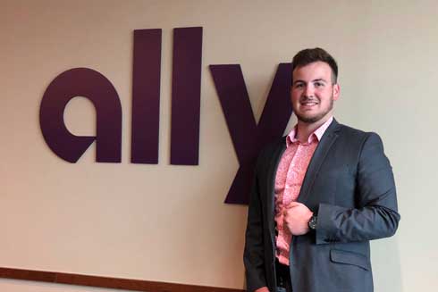 Mason Martell in front of the Ally company sign