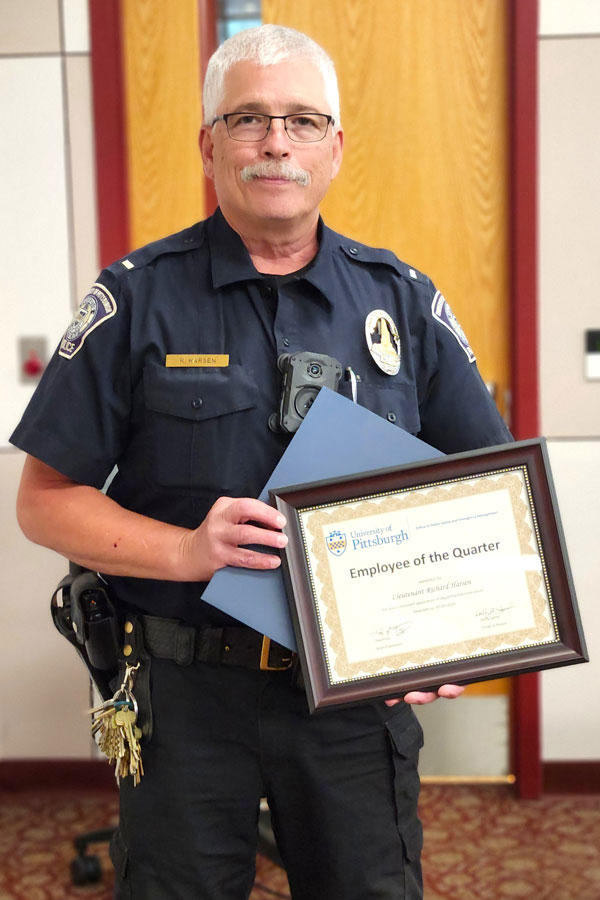Lt. Richard Harsen holding his award