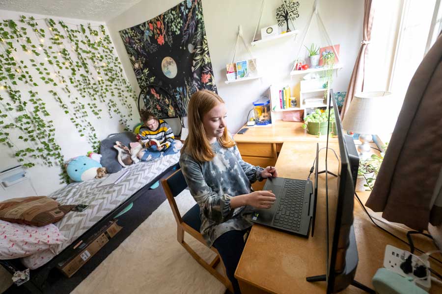 Student working at their desk in their dorm