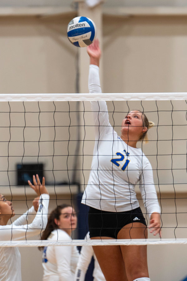 A girl about to spike a volleyball