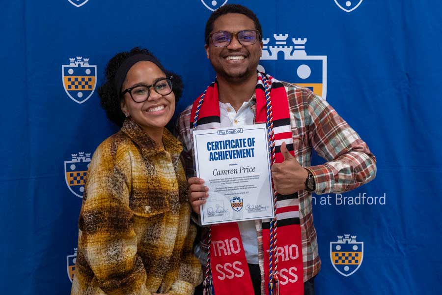 Two people smiling at graduation