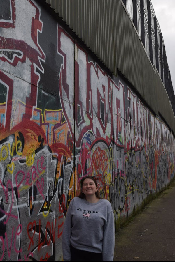 Abby Chapman in front of a graffiti wall