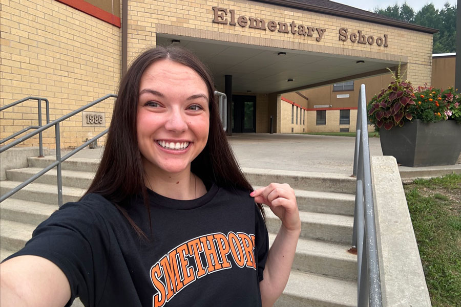 Gretchen standing in front of a school