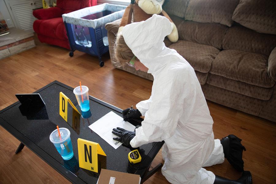 A child working with evidence in the CSI house