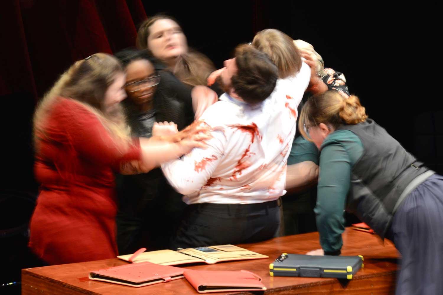 Students acting out a scene in a play