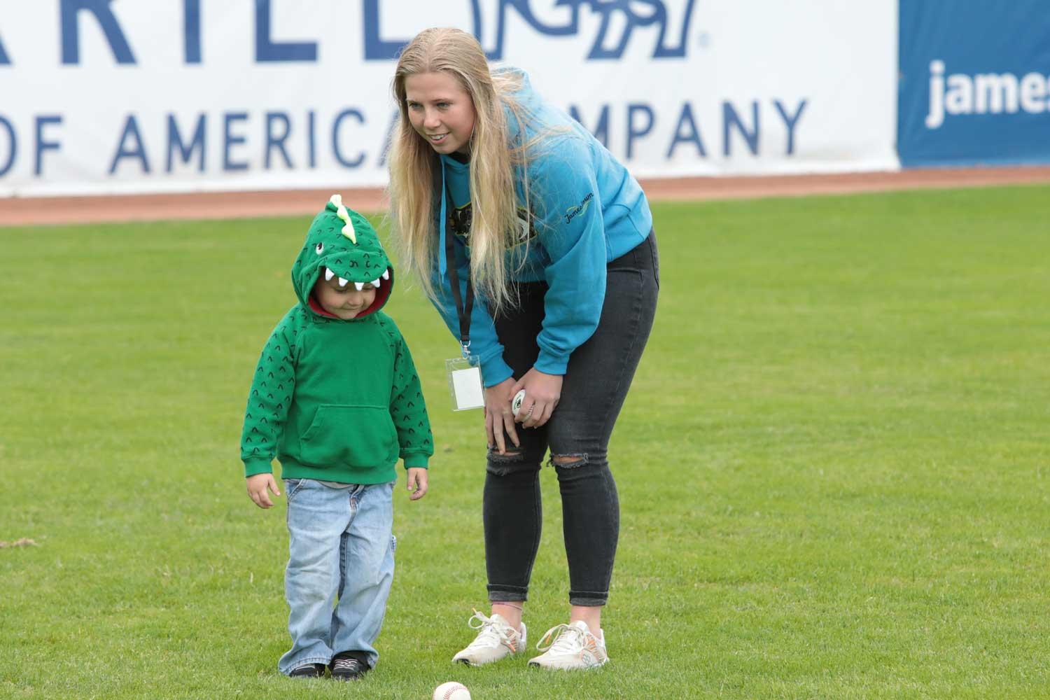 Ashton Beckerink with a child on a baseball field