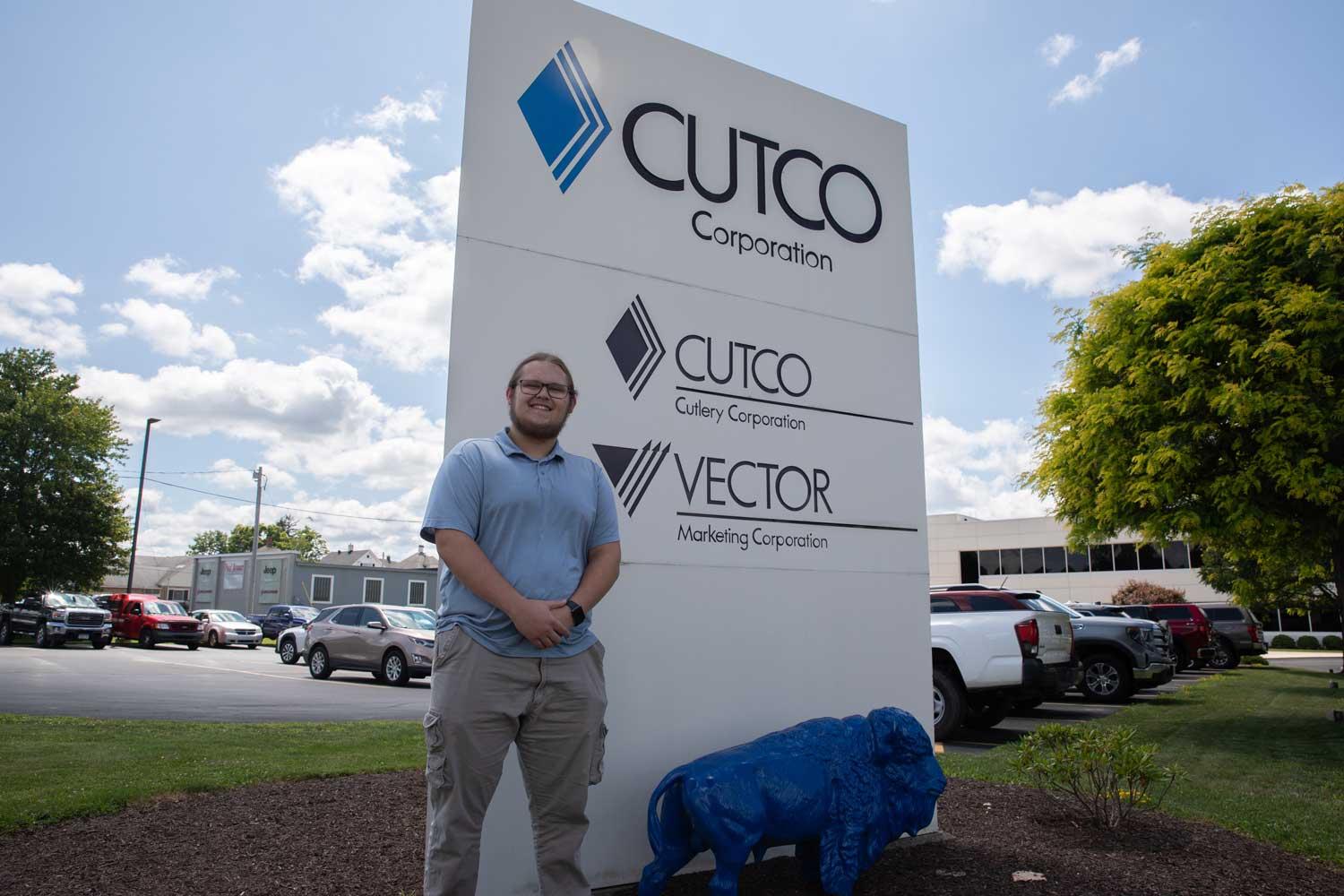 Billy Clayson III standing in front of the Cutco sign