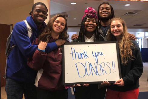 Students with sign