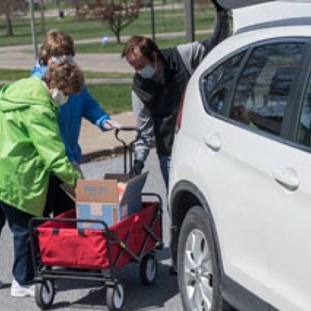People Loading Food into Minivan