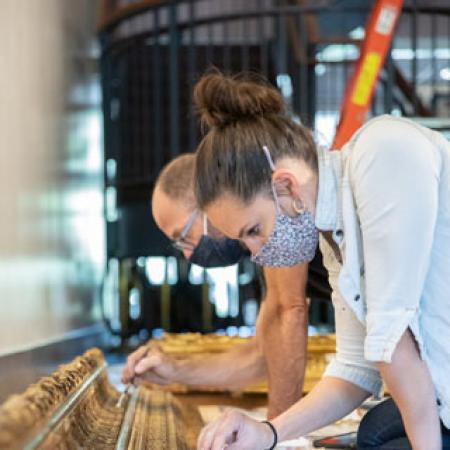 People Restoring Painting
