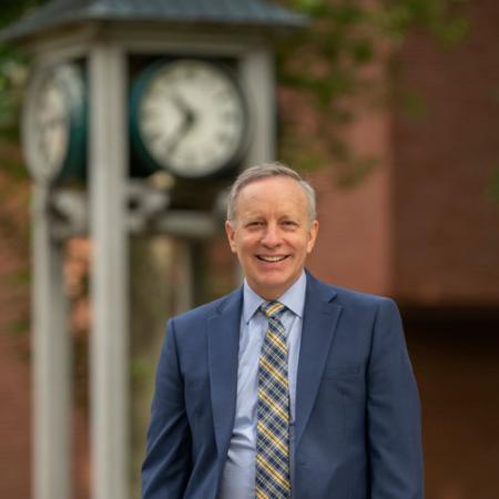 President Rick Esch in front of clock tower