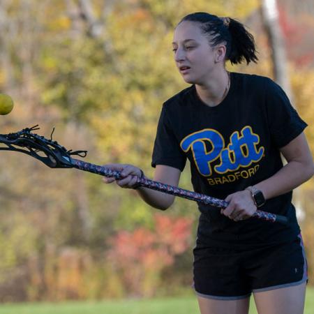 Student playing lacrosse