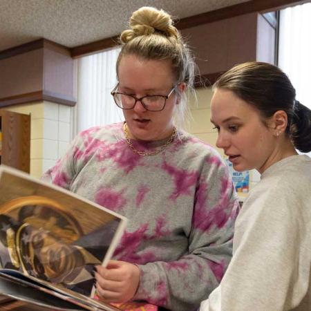 Students in childrens book section of library