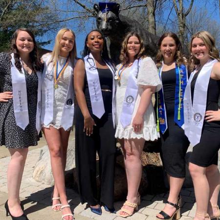 Six nursing graduates with panther