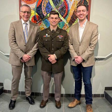 Photo of Nikolas Erickson with President Esch and Dean Davila