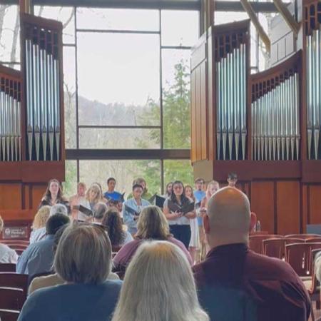 audience attending the vocal concert with singers in the front of the room