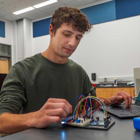 Student, Alex Marrone, working with circuits