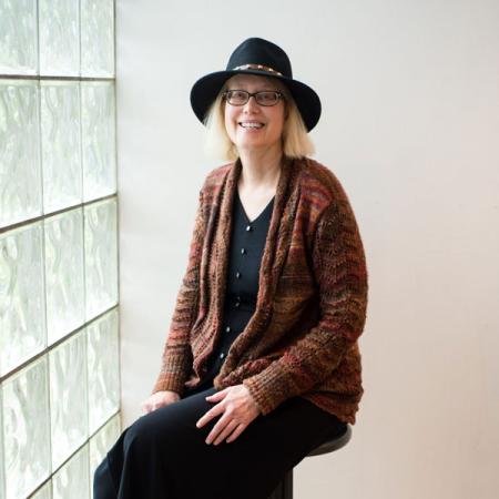 Dr. Nancy McCabe sitting in front of a window