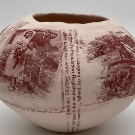 a photo of a pot with words and people on it