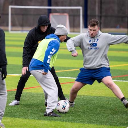 Soccer players practicing on new turf field