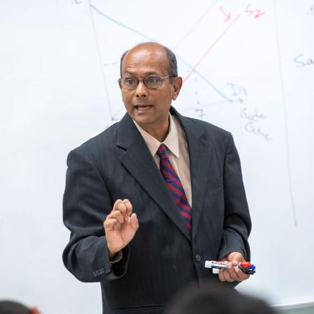 Dr. Gajanan teaching an economics class
