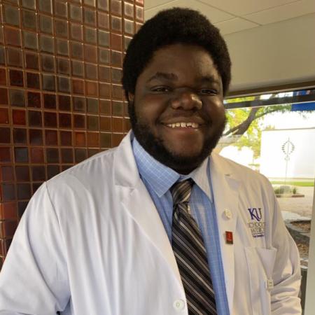 Olubumi Braimah in a lab coat