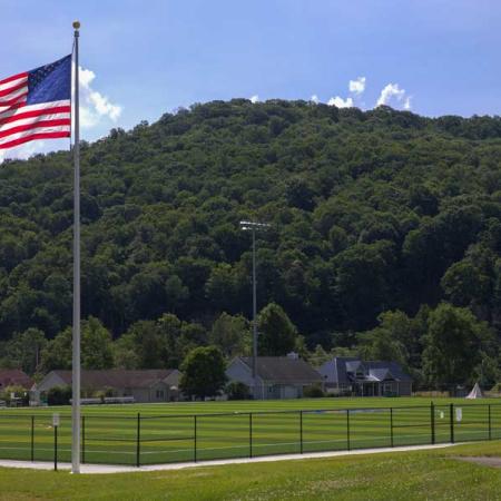 An American Flag waving above UPB turf field